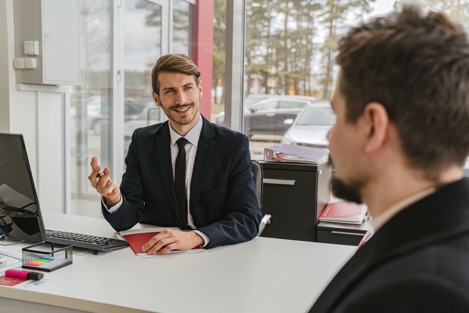 Deux hommes d'affaires discutant dans un bureau moderne.